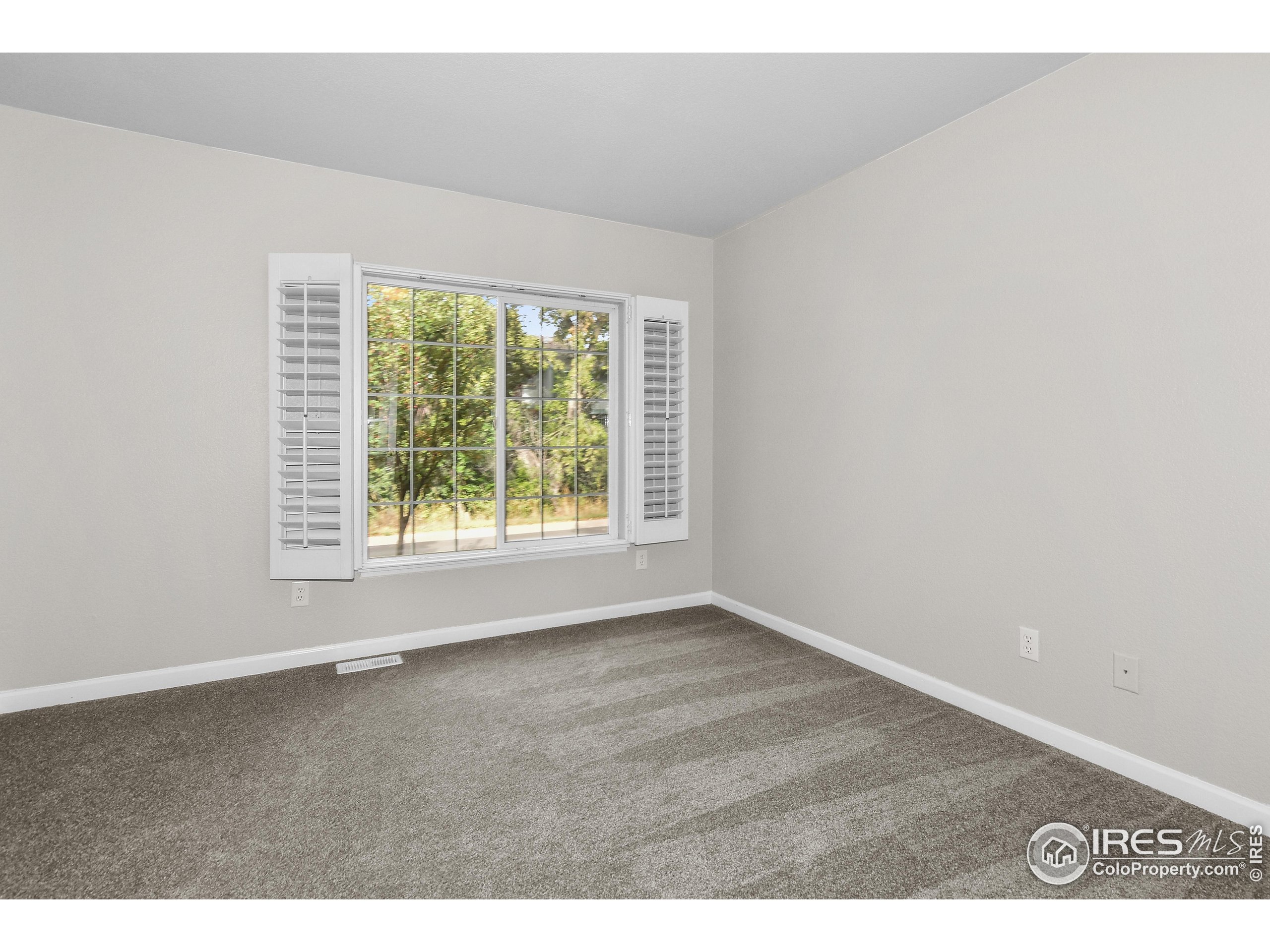 1680 Foxbrook Way Fort Collins, CO 80526 - Photo 5 of 42 an empty room with wooden floor and windows