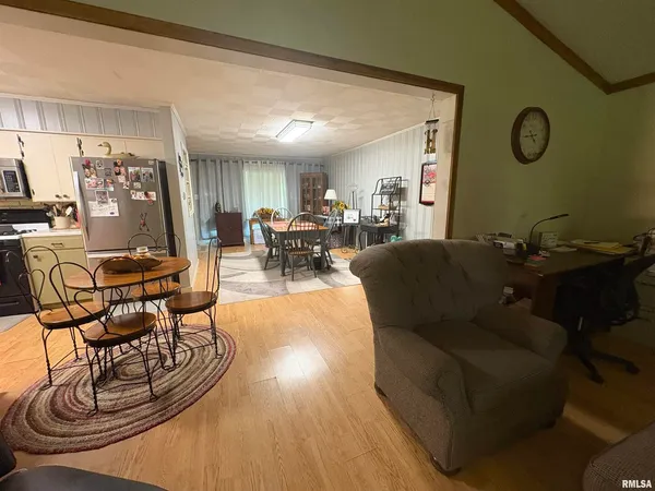 a living room with furniture a clock and a window