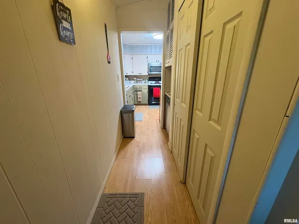 a view of a hallway with wooden floor