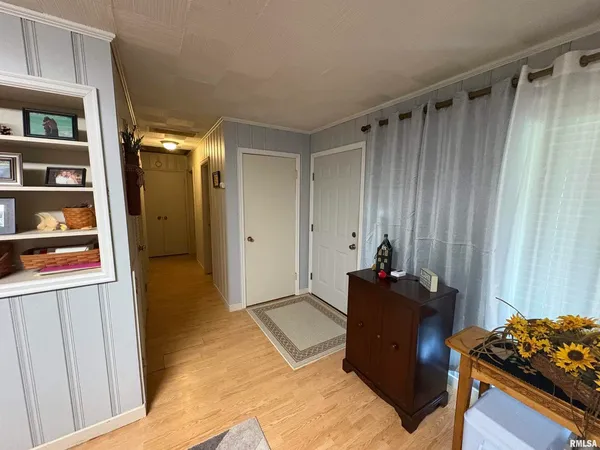 a living room with a bed and a window