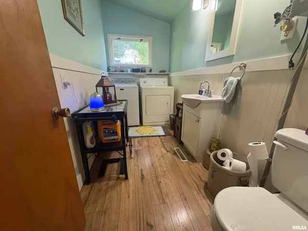 a bathroom with a toilet a sink and a mirror