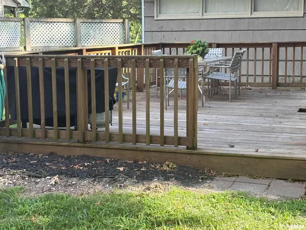a view of a brick house with a bench in patio