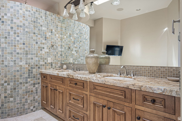 2331 West Entrada Trail, Unit 61 St. George, UT 84770 - Photo 29 of 69 Dual vanity with stone countertop, integrated sinks, and wood cabinetry