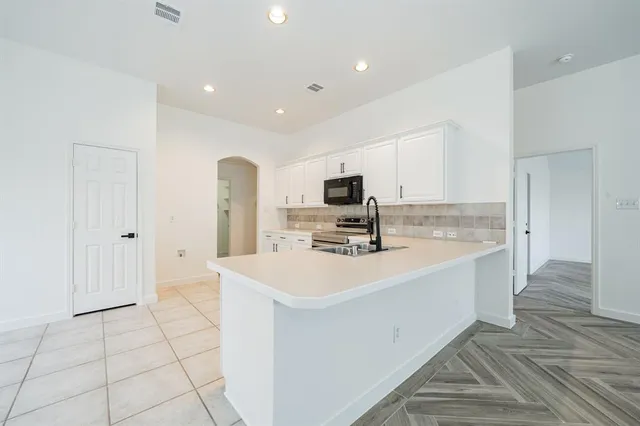 a view of kitchen with sink refrigerator and microwave