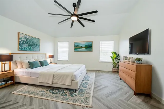 a bedroom with a bed and a flat screen tv