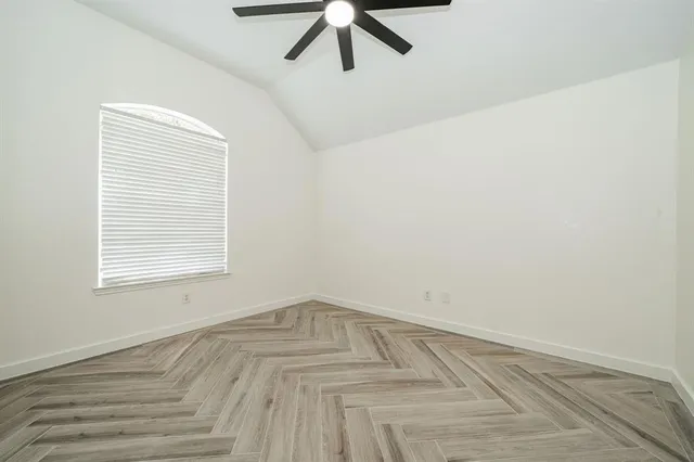 a view of a room with a window and a ceiling fan