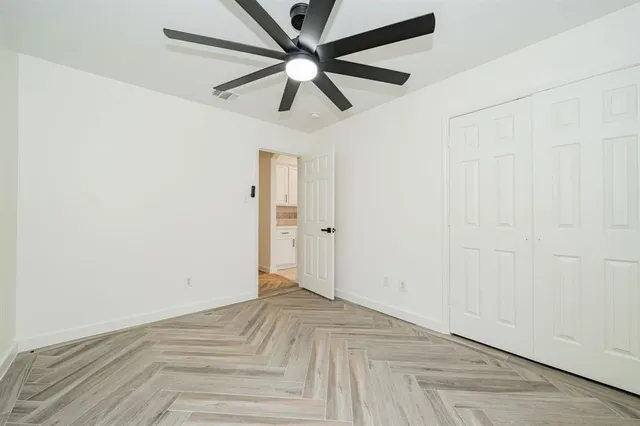 a view of a room with a ceiling fan