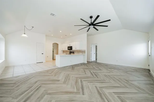 a view of a kitchen with a sink hardwood floor and a ceiling fan