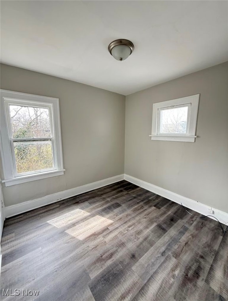 1743 Algonac Road Cleveland, OH 44112 - Photo 8 of 19 Spare room featuring baseboards and wood finished floors