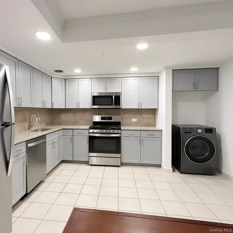 a kitchen with a sink a stove and cabinets