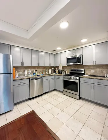 a kitchen with stainless steel appliances and white cabinets