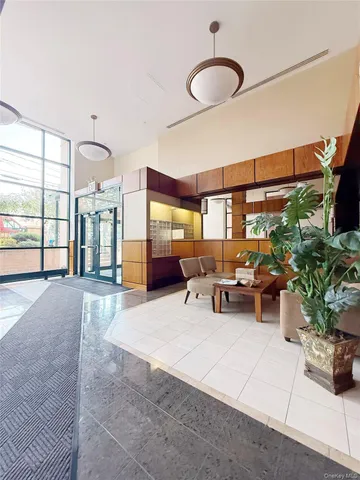 a living room with furniture gym equipment and a large window