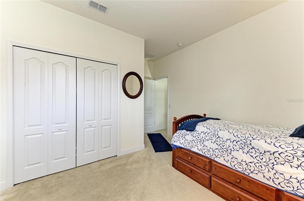 302 Cockle Shell Loop Apollo Beach, FL 33572 - Photo 50 of 75 a bedroom with a bed and cabinets