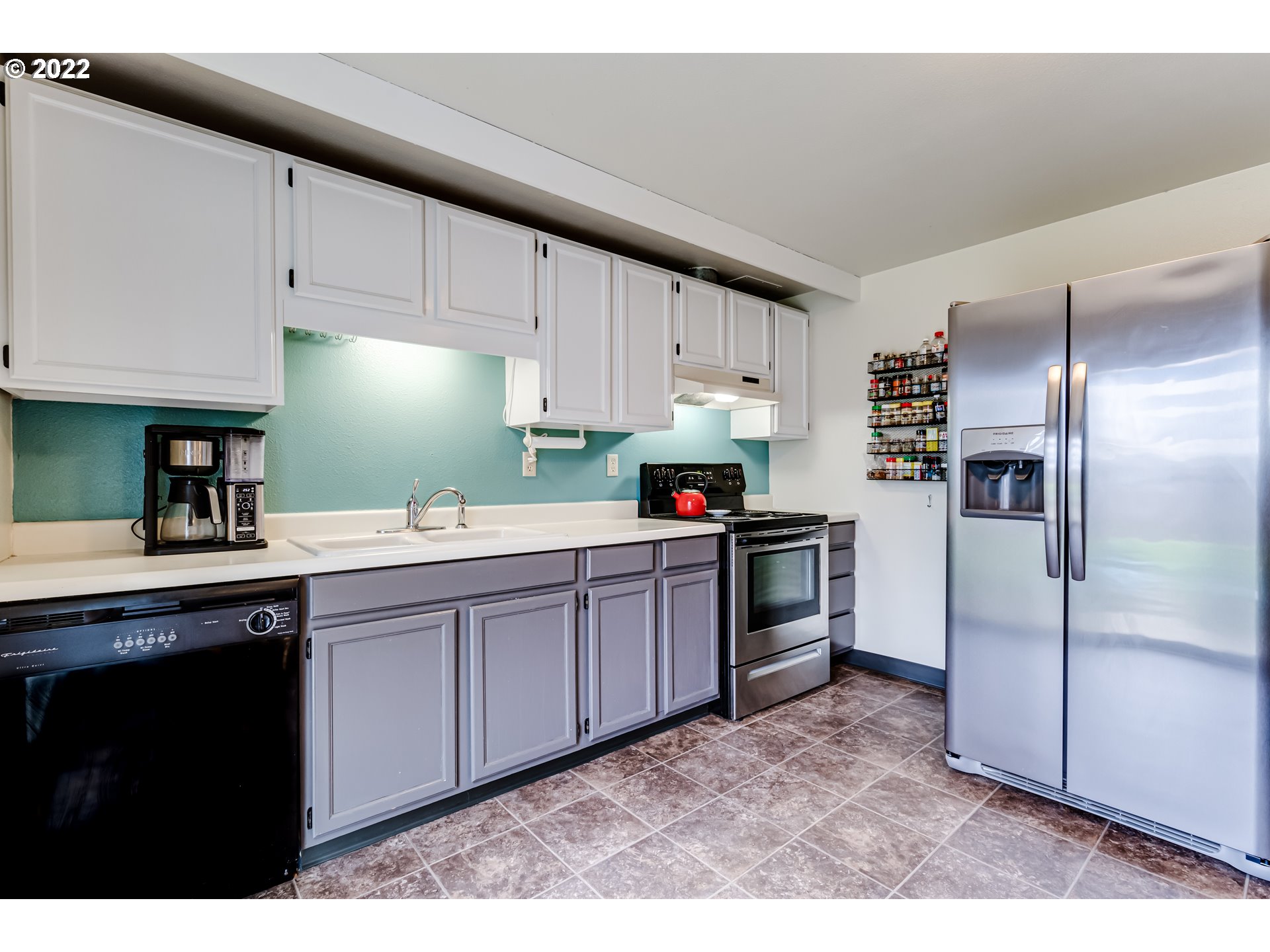 2634 J Street Springfield, OR 97477 - Photo 7 of 20 a kitchen with granite countertop a refrigerator sink and cabinets