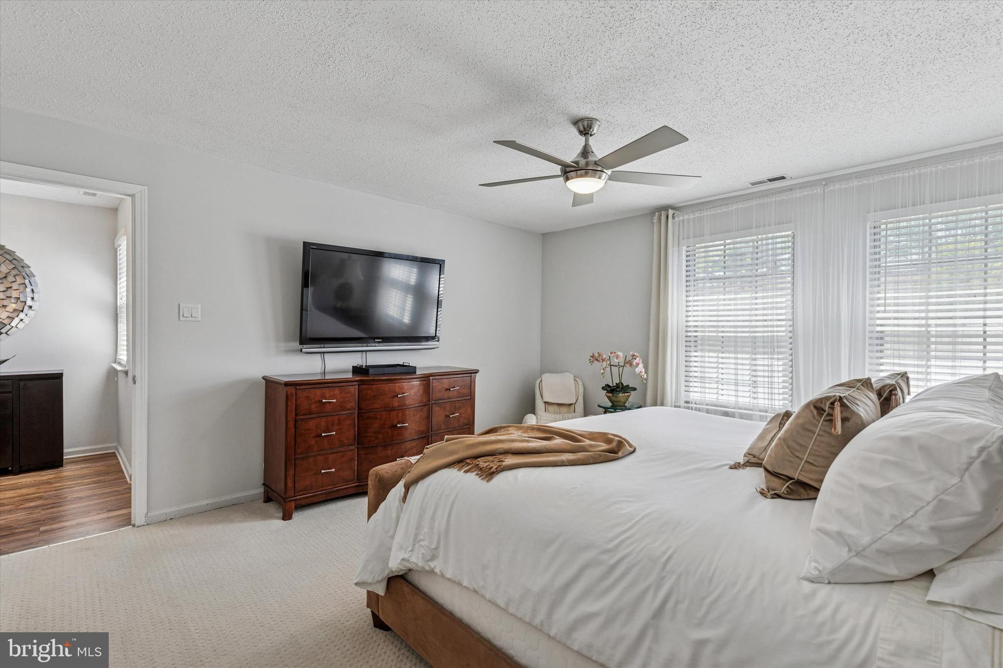 8 Hopkinson Court Chesterbrook, PA 19087 - Photo 15 of 25 a bedroom with a bed and a flat screen tv