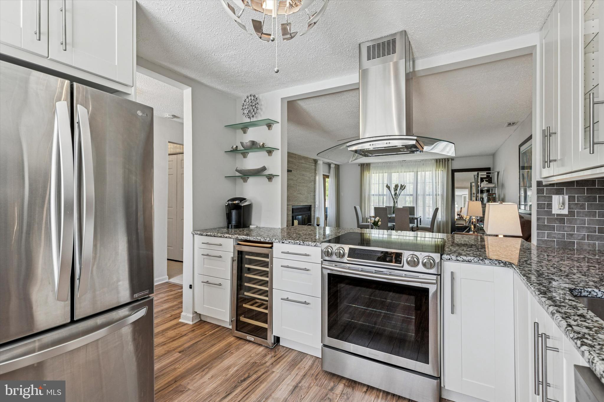 8 Hopkinson Court Chesterbrook, PA 19087 - Photo 10 of 25 a kitchen with stainless steel appliances a stove a refrigerator and a fireplace