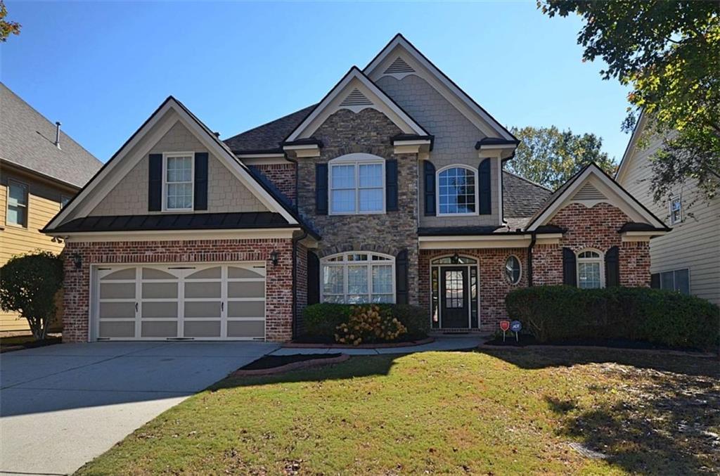 101 Whitegrass Way Grayson, GA 30017 - Photo 1 of 41 a front view of a house with a yard and garage