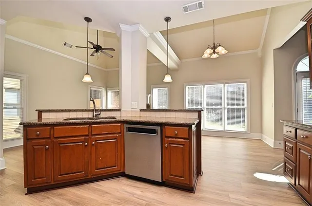 a open kitchen with a sink and dishwasher with a large window