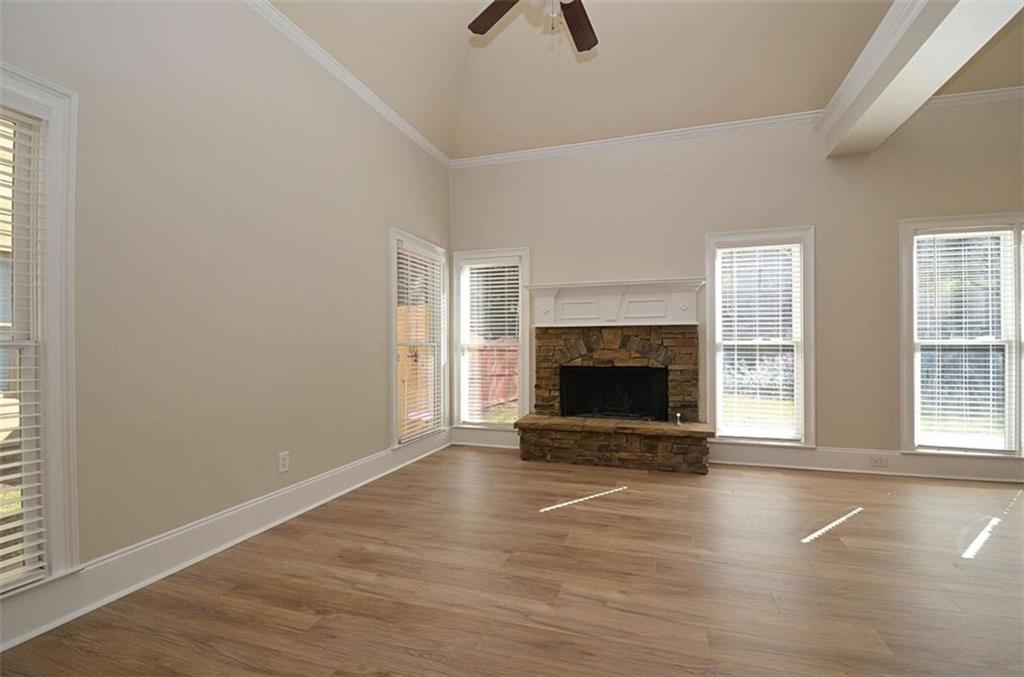 101 Whitegrass Way Grayson, GA 30017 - Photo 13 of 41 an empty room with floor to ceiling window and fireplace