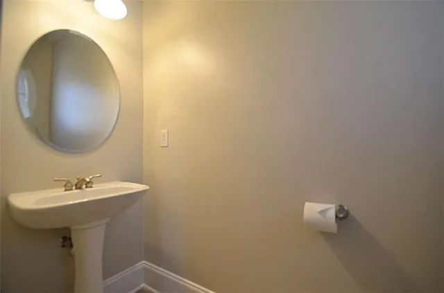 a bathroom with a sink and mirror