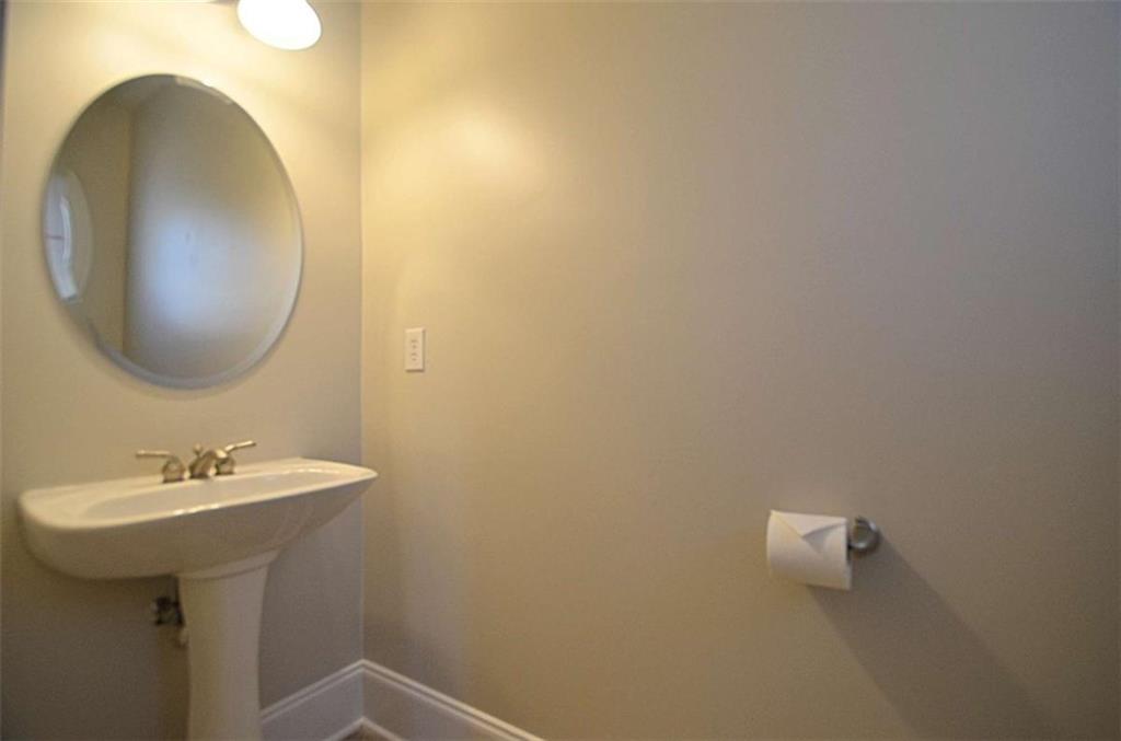 101 Whitegrass Way Grayson, GA 30017 - Photo 16 of 41 a bathroom with a sink and mirror