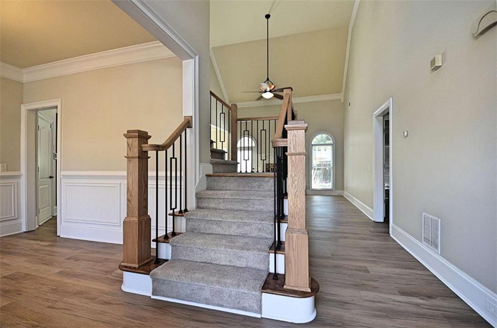 101 Whitegrass Way Grayson, GA 30017 - Photo 2 of 41 a view of a hallway with wooden floor and staircase