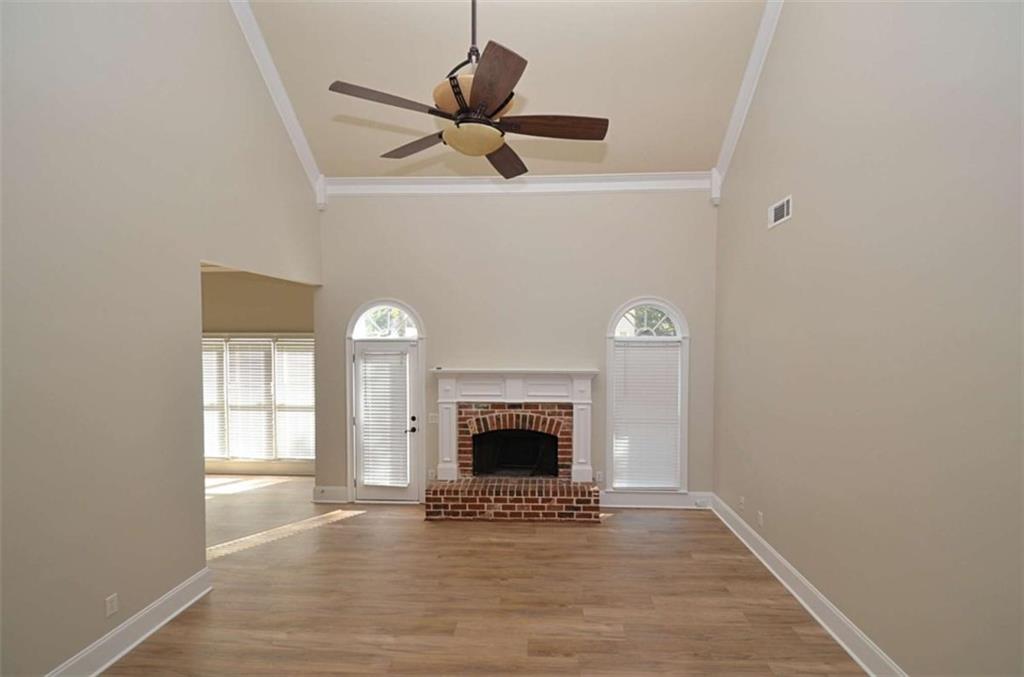 101 Whitegrass Way Grayson, GA 30017 - Photo 21 of 41 a view of an empty room with wooden floor and a window