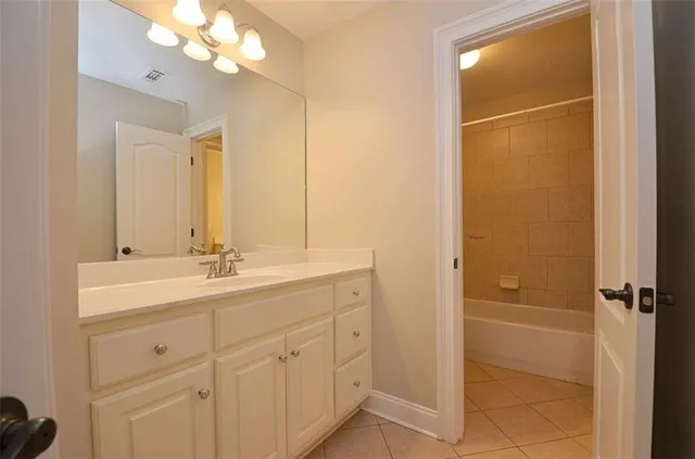 a bathroom with a double vanity sink a mirror and shower