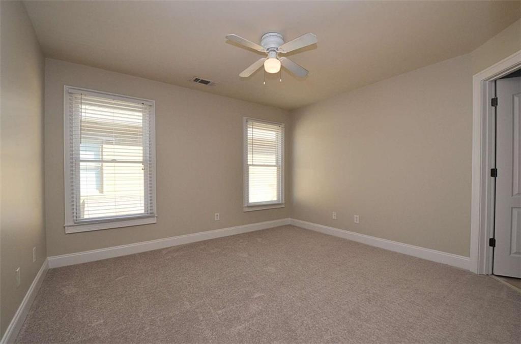 101 Whitegrass Way Grayson, GA 30017 - Photo 27 of 41 an empty room with a window and a ceiling fan