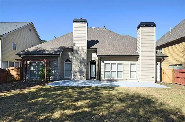 a view of a house with large trees