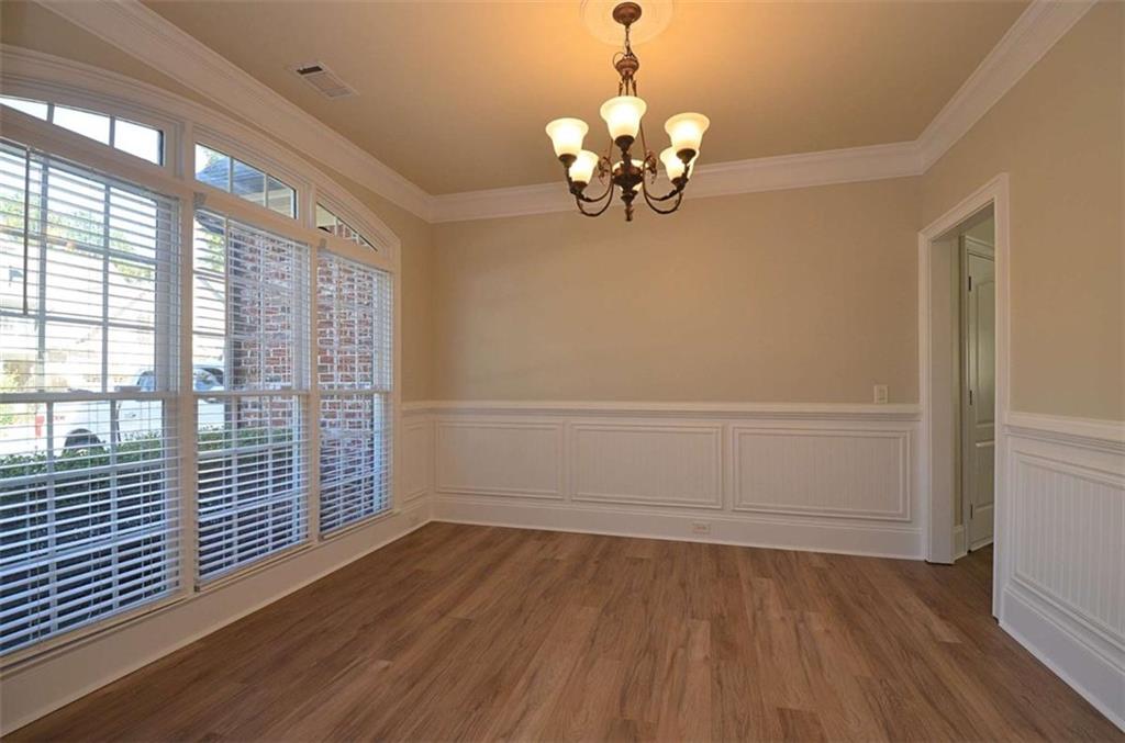 101 Whitegrass Way Grayson, GA 30017 - Photo 3 of 41 wooden floor in an empty room with a window