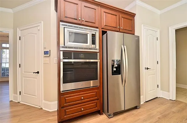a view of kitchen with stainless steel appliances granite countertop cabinets and a window