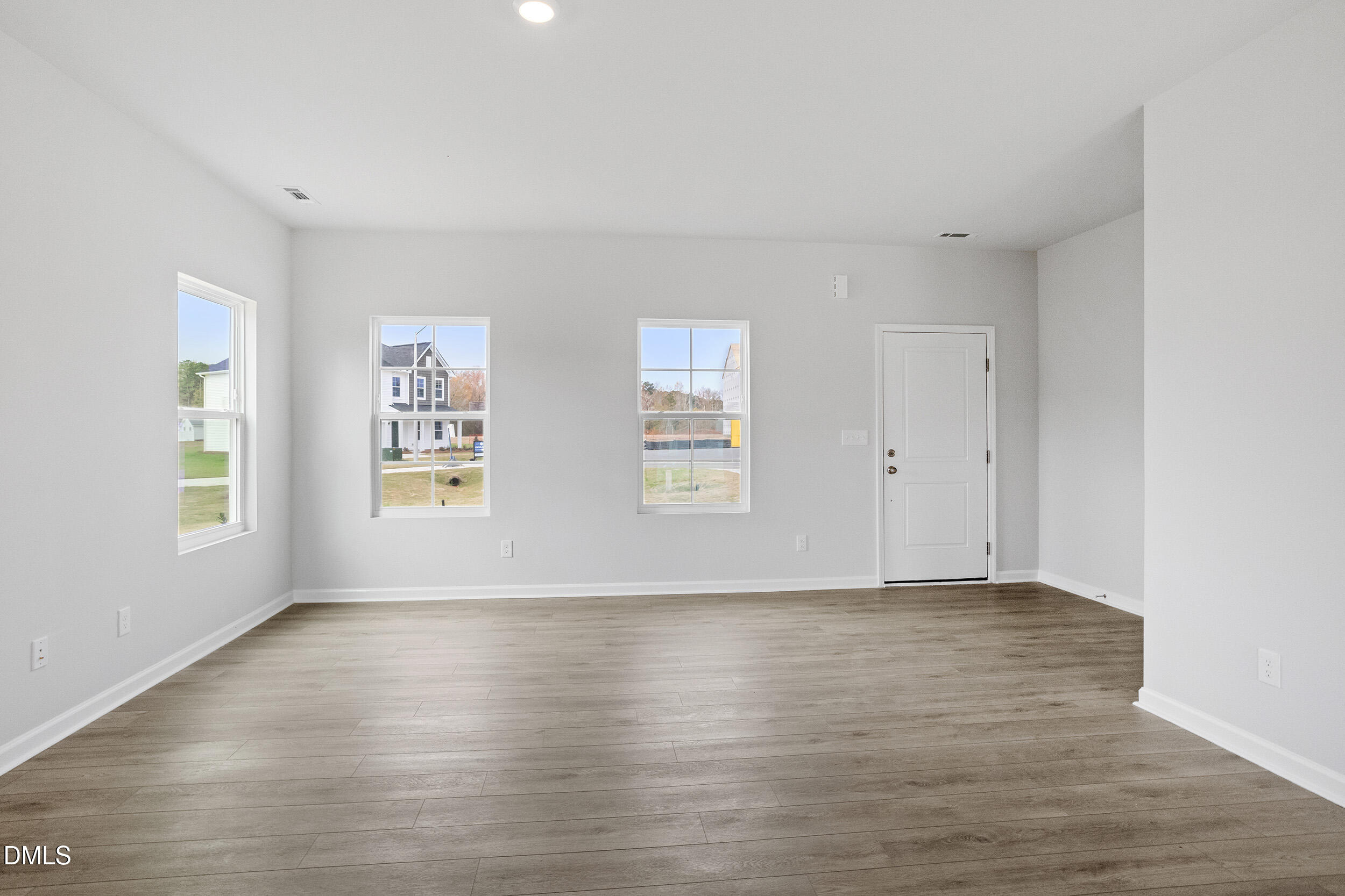 79 Osgood Street Angier, NC 27501 - Photo 11 of 31 a view of an empty room with wooden floor and a window