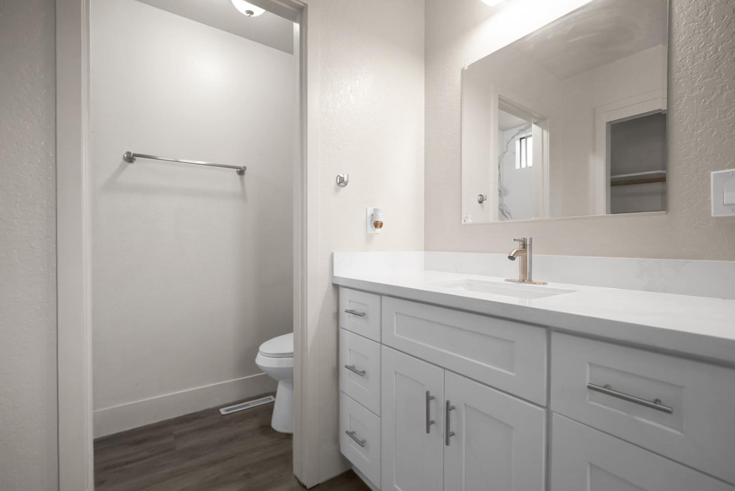 2832 Fowler Road Ceres, CA 95307 - Photo 11 of 28 a bathroom with a sink a toilet and a mirror
