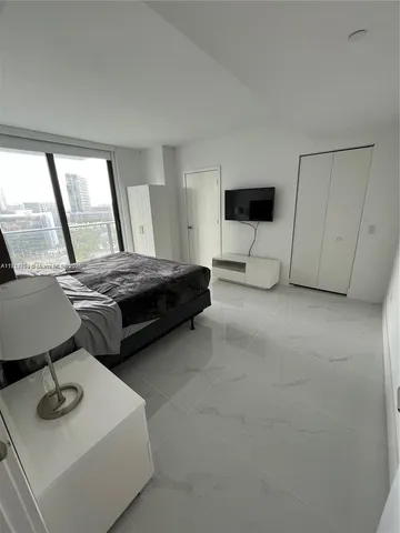 a bedroom with bed and window