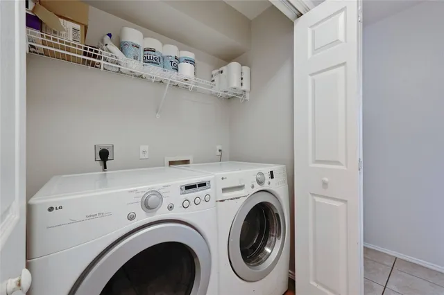 a view of washer and dryer with kitchen in the background
