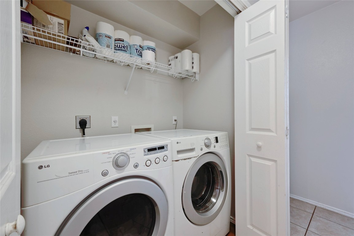 1709 Friars Tale Lane Austin, TX 78748 - Photo 18 of 24 a view of washer and dryer with kitchen in the background