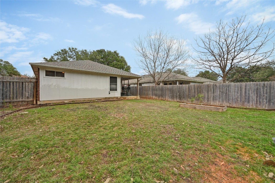 1709 Friars Tale Lane Austin, TX 78748 - Photo 22 of 24 a front view of a house with garden