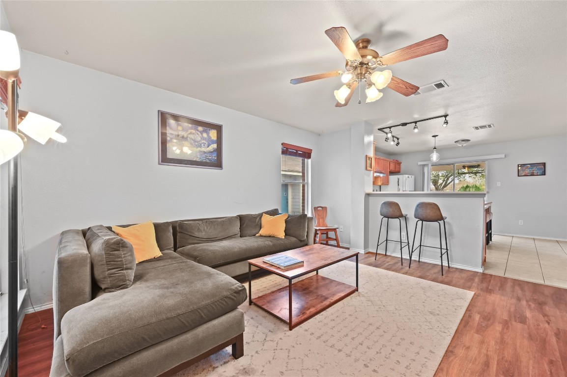 1709 Friars Tale Lane Austin, TX 78748 - Photo 4 of 24 a living room with furniture a chandelier and a wooden floor