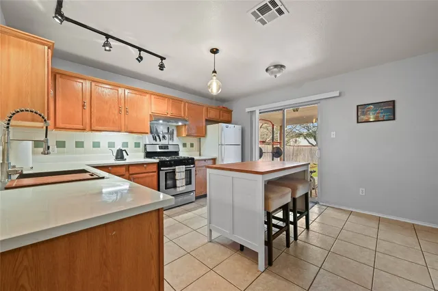 a kitchen with granite countertop a sink appliances counter top space and furniture