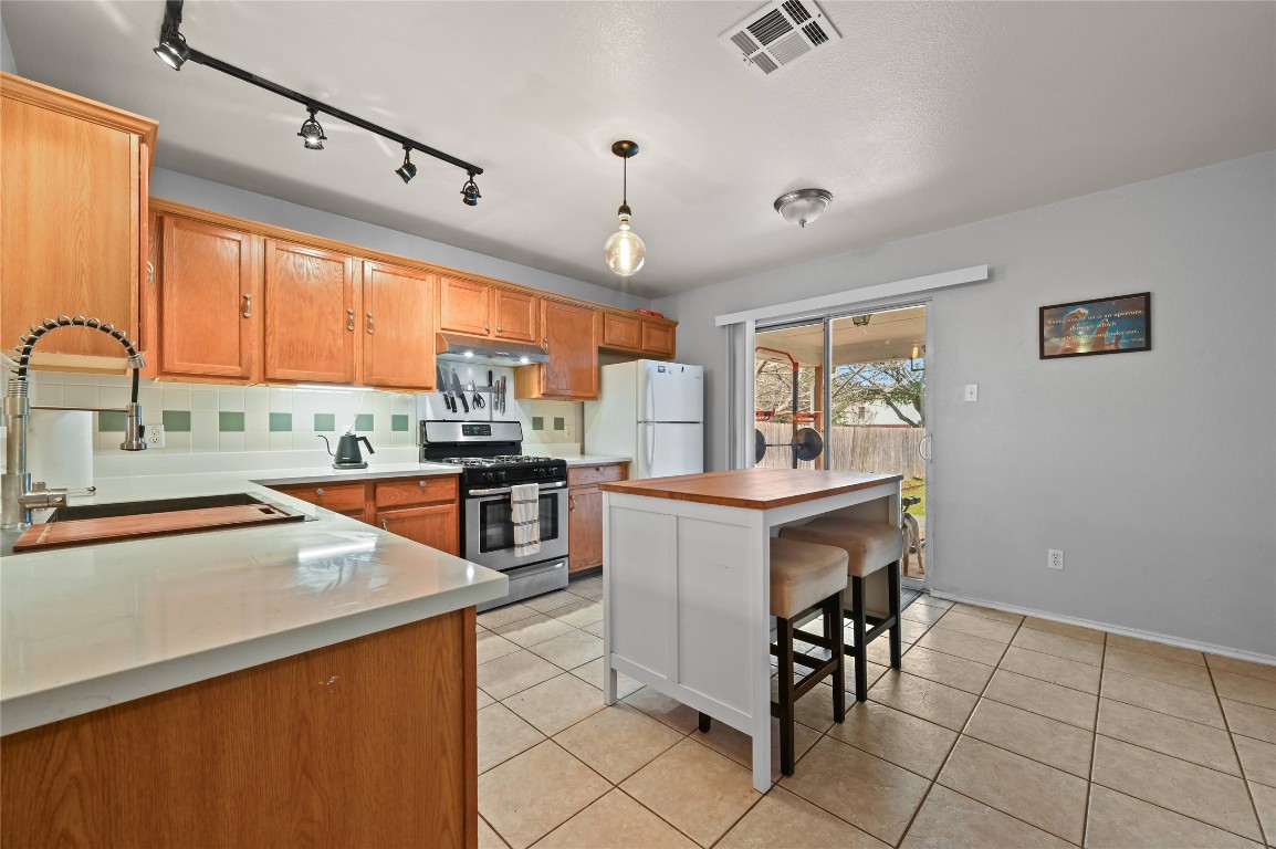 1709 Friars Tale Lane Austin, TX 78748 - Photo 7 of 24 a kitchen with granite countertop a sink appliances counter top space and furniture