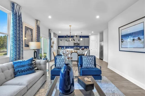 a living room with furniture and a chandelier