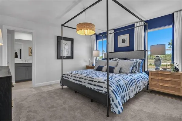 a bedroom with a bed and a chandelier