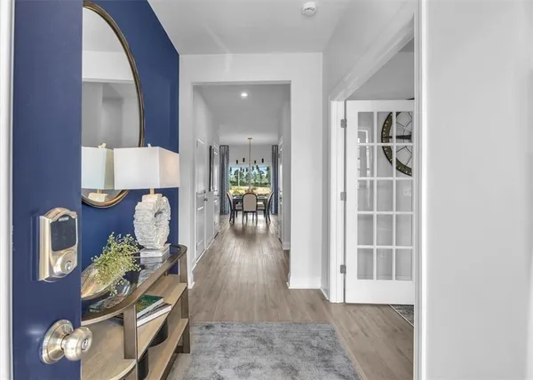 a living room with furniture and a wooden floor