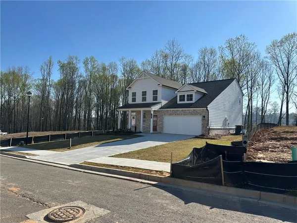 a view of pool with lawn chairs and large trees