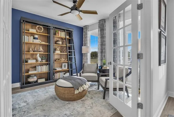 a kitchen with stainless steel appliances granite countertop a table chairs in it and wooden floors