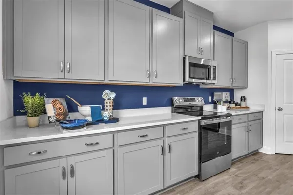 a kitchen with white cabinets and white appliances