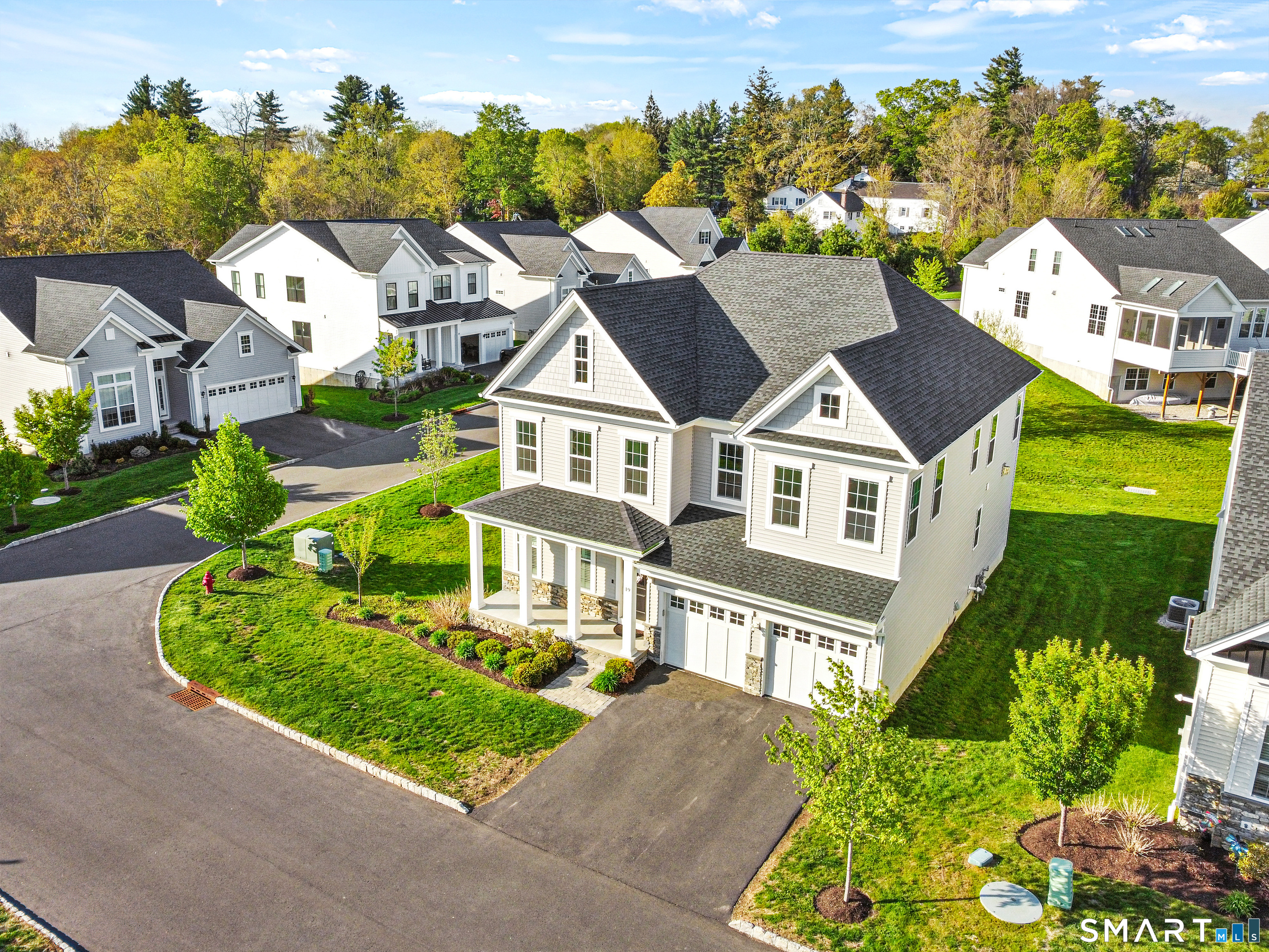 an aerial view of multiple houses with a yard