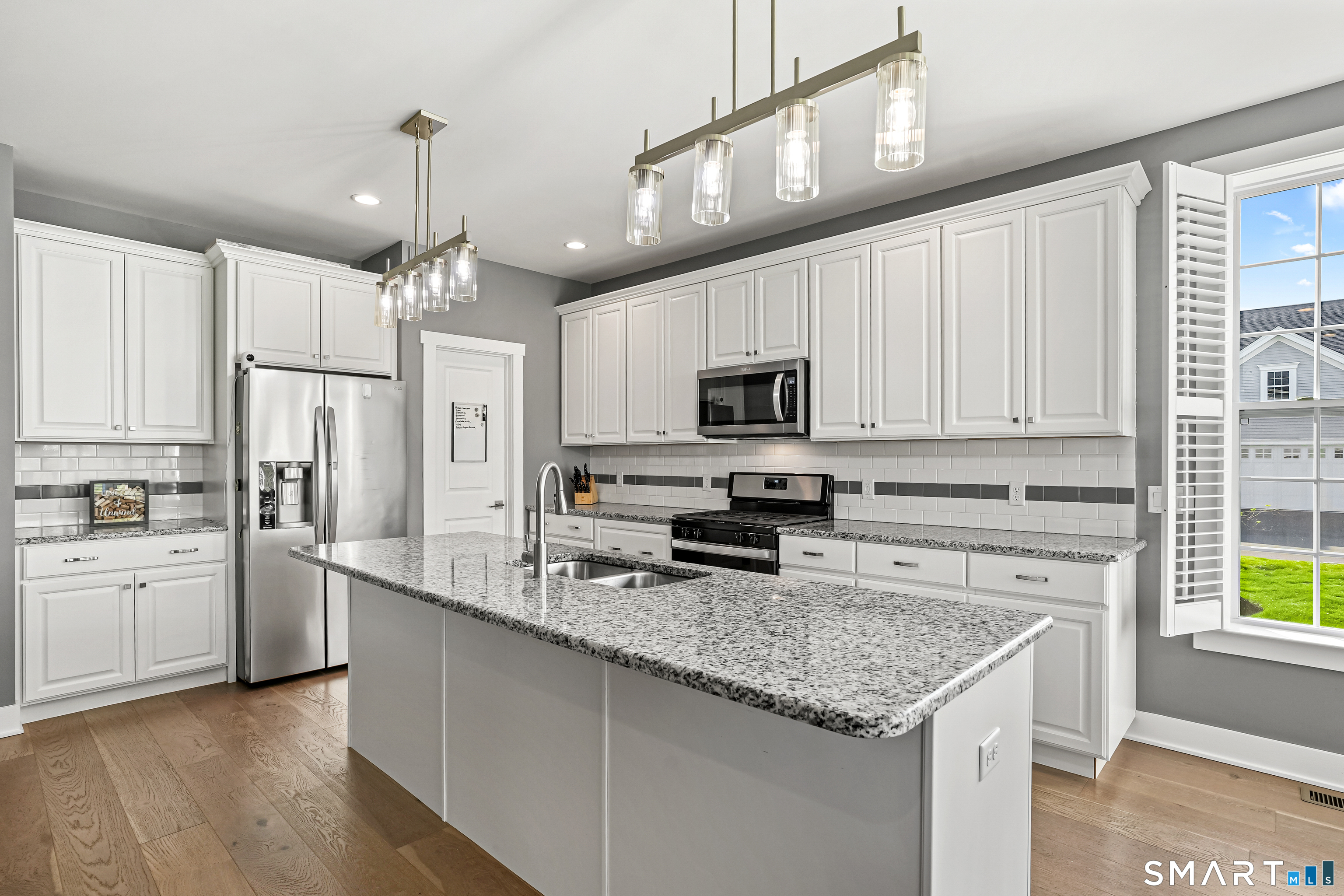 19 Enclave Circle, Unit 19 Newtown, CT 06470 - Photo 2 of 39 a kitchen with white cabinets and appliances