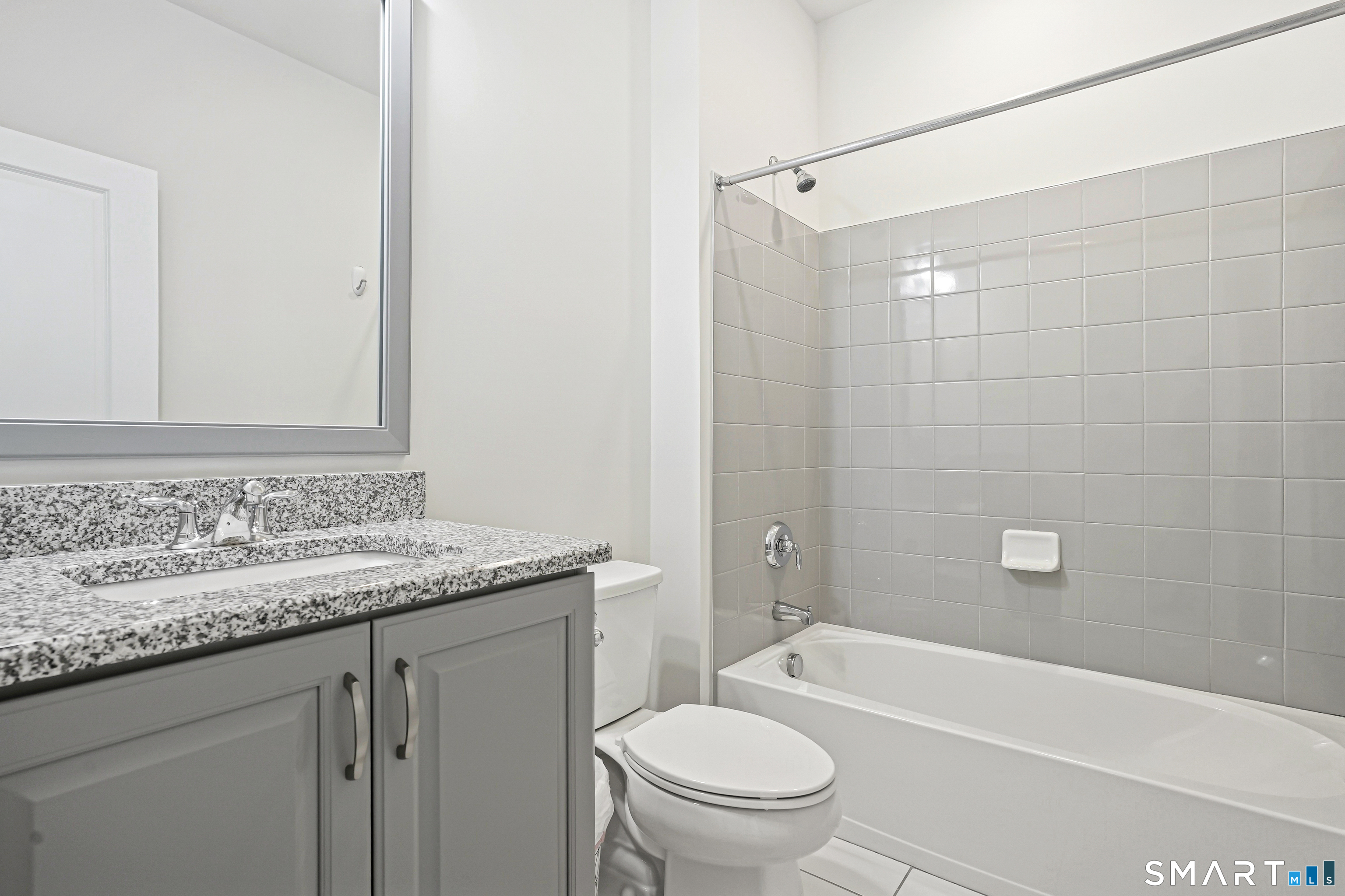 19 Enclave Circle, Unit 19 Newtown, CT 06470 - Photo 25 of 39 a bathroom with a granite countertop sink a toilet and bathtub